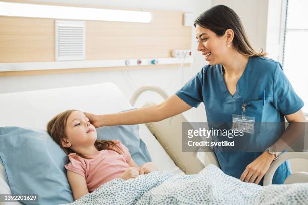 little girl in hospital bed - bedside manner stock pictures, royalty-free photos & images