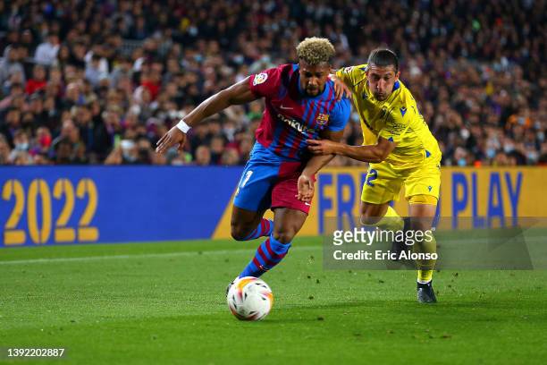 Adama Traore of Barcelona is challenged by Alfonso Espino of Cadiz during the LaLiga Santander match between FC Barcelona and Cadiz CF at Camp Nou on...