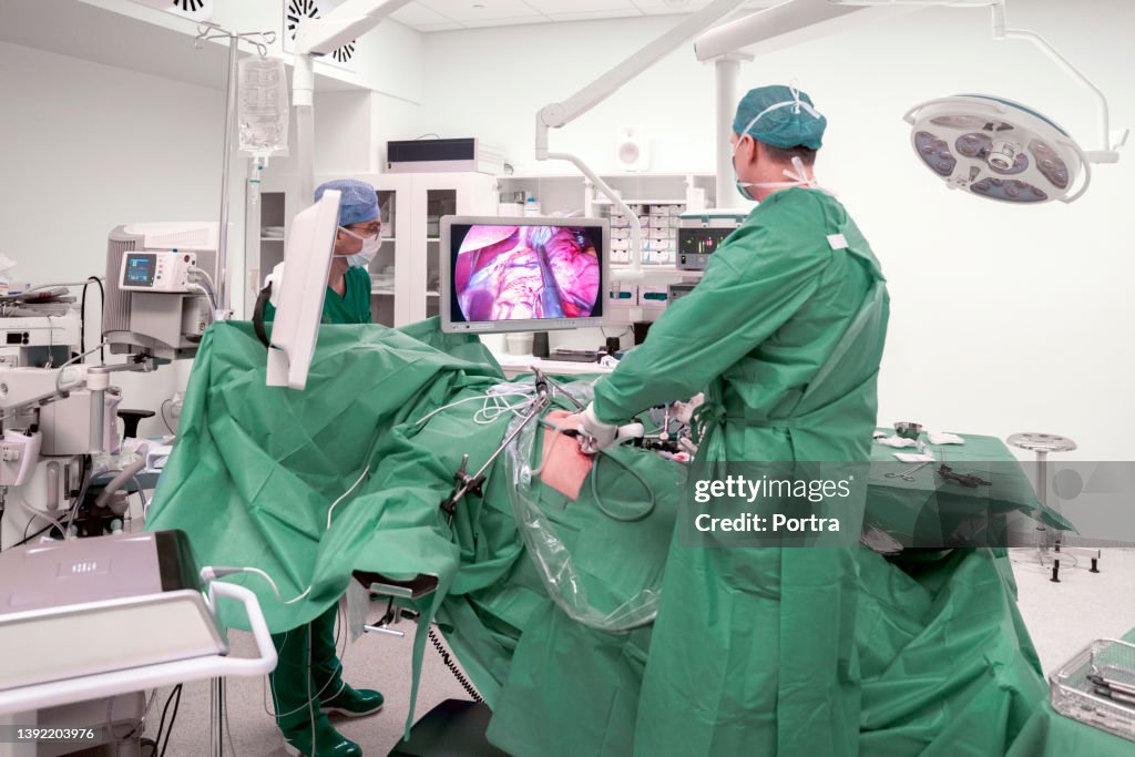 Surgeons performing surgery on a patient in operation room