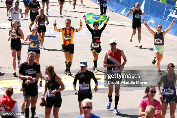 Runners cross the finish line during the 126th Boston Marathon on April 18, 2022 in Boston, Massachusetts.