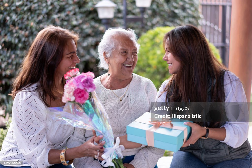 Three generations portrait celebrating motherâs day all smiling very happy