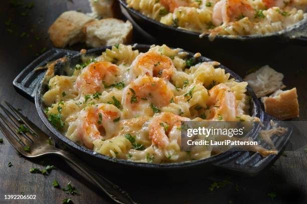 baked shrimp and rotini in a garlic white wine sauce - scampi stock pictures, royalty-free photos & images