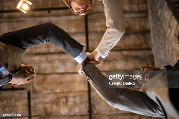 happy business people gibing each other high-five. - three people working together stock pictures, royalty-free photos & images