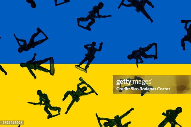 toy soldiers war over background of ukrainian flag - fight for the troops stock pictures, royalty-free photos & images