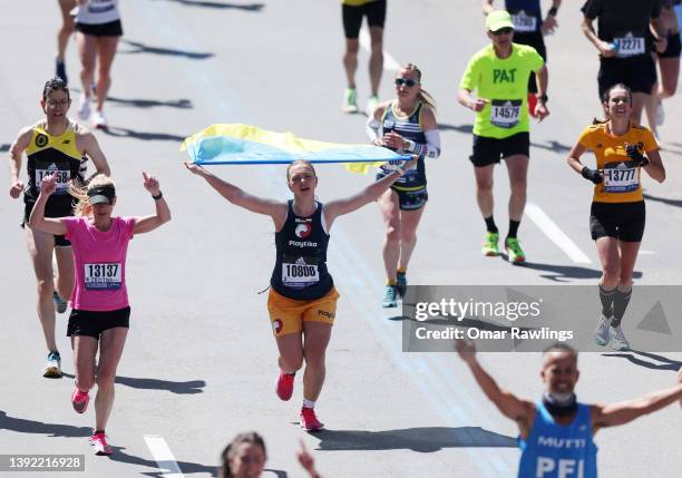 Runner makes their way down Boylston street carrying a Ukrainian flag to the finish line during the 126th Boston Marathon on April 18, 2022 in...