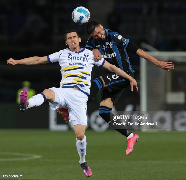 Kevin Lasagna of Hellas Verona jumps for the ball against Jose Palomino of Atalanta BC during the Serie A match between Atalanta BC and Hellas Verona...