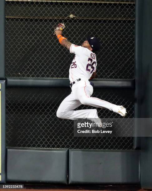 Jose Siri of the Houston Astros makes a catch at the wall on a fly ball off the bat of Max Stassi of the Los Angeles Angels in the third inning of...