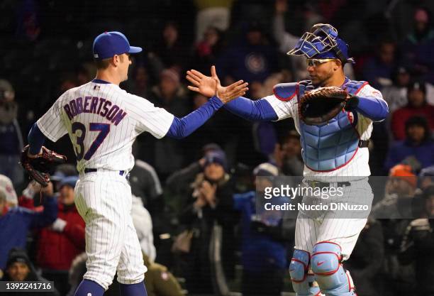David Robertson of the Chicago Cubs hugs Willson Contreras of the Chicago Cubs after the last out against the Tampa Bay Rays at Wrigley Field on...