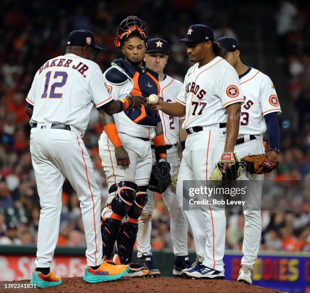 Manager Dusty Baker Jr. #12 of the Houston Astros takes starter Luis Garcia out of the game in the sixth inning of the home opener at Minute Maid...