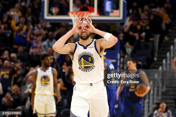 Klay Thompson of the Golden State Warriors reacts after Stephen Curry made a three-point basket against the Denver Nuggets in the first half during...