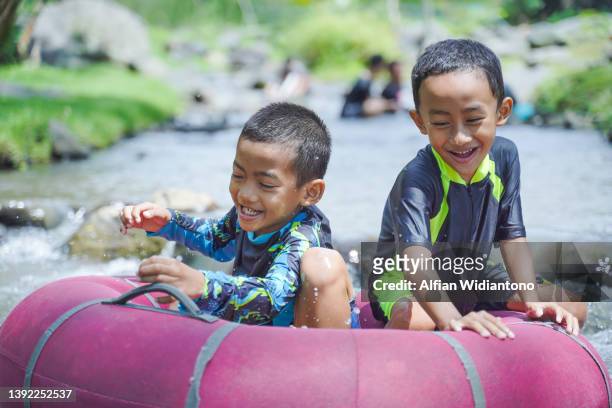 playing in the river - kids at river stock pictures, royalty-free photos & images