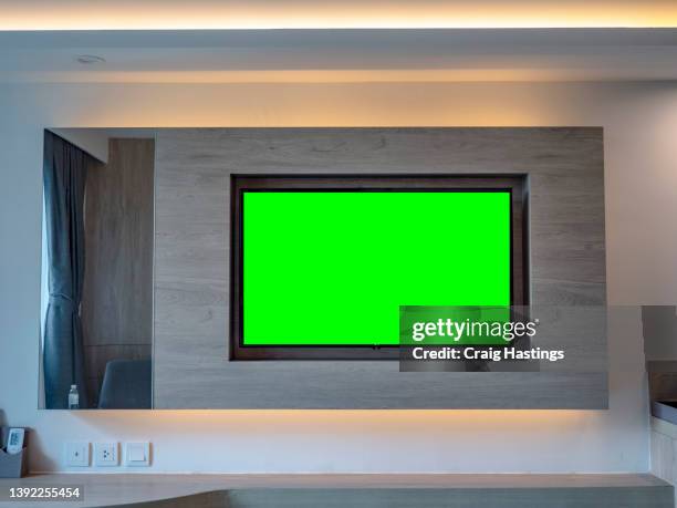 luxury hotel bedroom tv media entertainment centre green screen chroma key digital display. - chroma key stock pictures, royalty-free photos & images