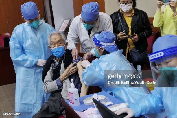 An elderly man receives COVID-19 vaccine at Chinese Academy of Social Sciences on April 18, 2022 in Beijing, China.
