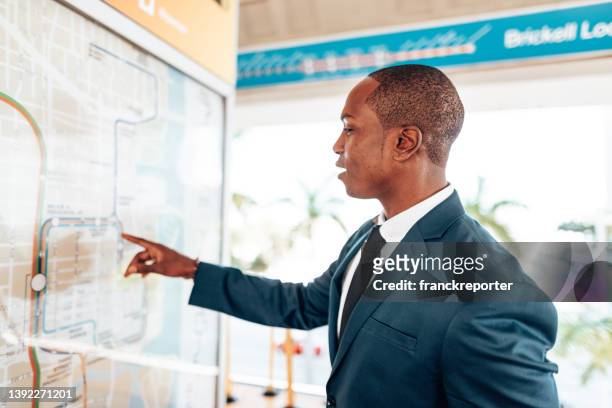 business man looking at the metro map - looking at subway map stock pictures, royalty-free photos & images