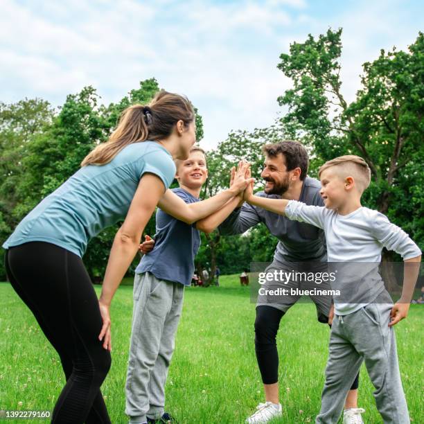 high five for the family - family jogging stock pictures, royalty-free photos & images