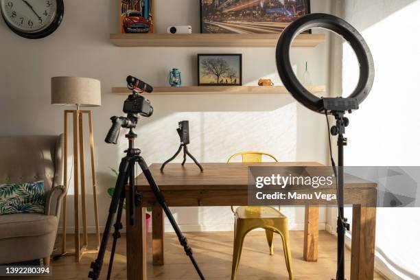 set at home equipped for influencer such as ring of light, reflex camera and a led panel - vlogger stockfoto's en -beelden