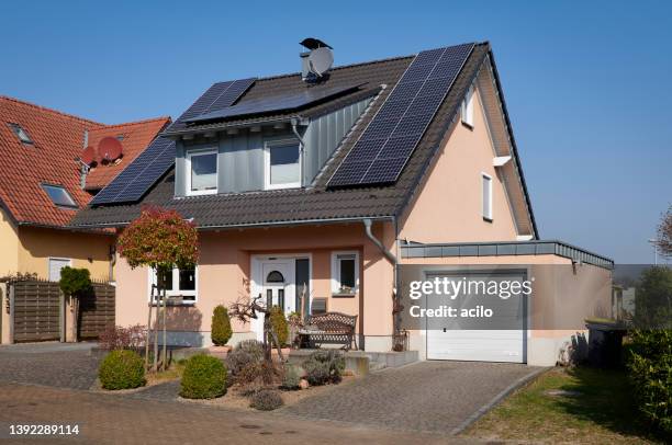 rose colored one family house with garage and solar panels - detached stock pictures, royalty-free photos & images