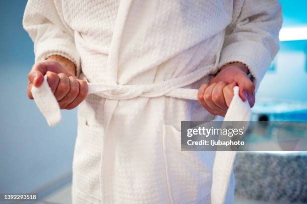 man tying belt on his bathrobe - bathrobe stock pictures, royalty-free photos & images