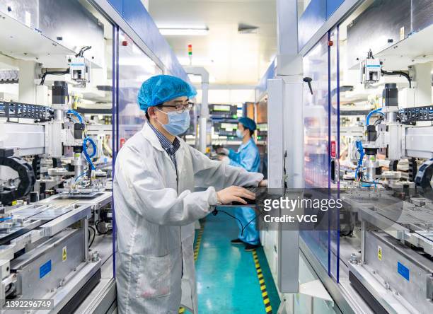 Employees work on the production line of solar panels at a workshop of Jiangsu Fox Group Co., Ltd on April 18, 2022 in Hai an, Nantong City, Jiangsu...