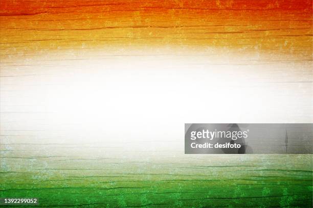 a horizontal rustic vector wooden background of tricolour painted bands, saffron or orange, white and green colours with a glowing middle having wood grain pattern all over - india flag stock illustrations