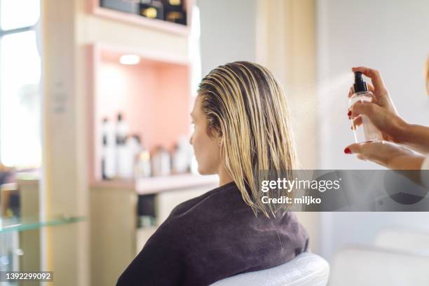 woman at hairdresser - hair treatment stock pictures, royalty-free photos & images