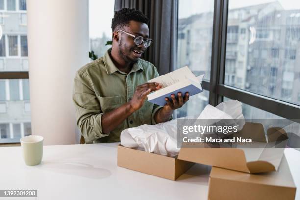 young man has ordered books online - carton stock pictures, royalty-free photos & images