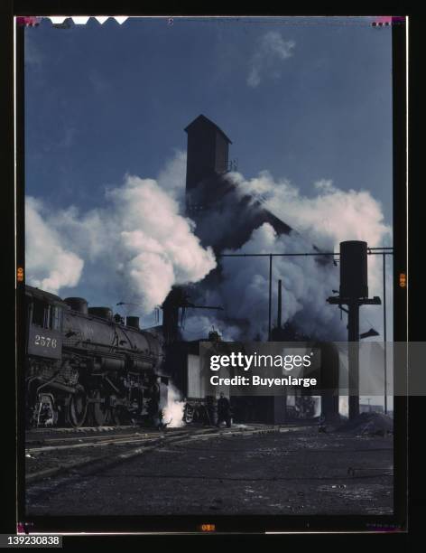 Locomotives over the ash pit at the roundhouse and coaling station at the Chicago and Northwestern Railroad yards, Chicago, Illinois, 1942.