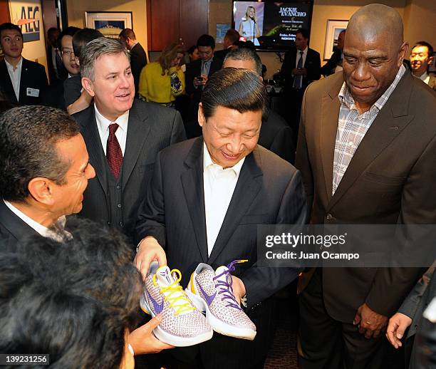 Chinese Vice President Xi Jinping is presented with a pair of shoes by Los Angeles Mayor Antonio Villaraigosa, AEG President and CEO Tim Leiweke, and...