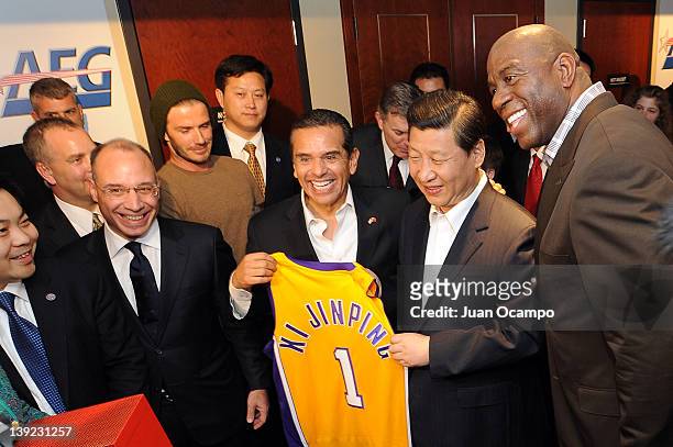 Chinese Vice President Xi Jinping is presented with a jersey by President and CEO of AEG China John Cappo, Los Angeles Galaxy star David Beckham, Los...
