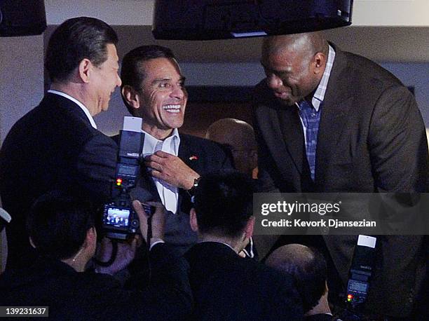 Chinese Vice President Xi Jinping greets NBA great and former Los Angeles Laker Magic Johnson next to Los Angeles Mayor Antonio Villaraigosa at the...