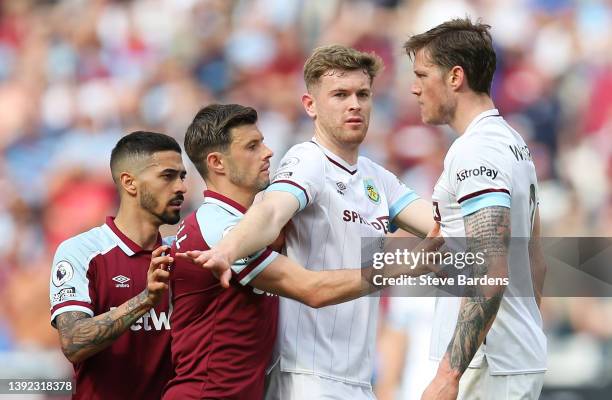 Declan Rice of West Ham United clashes with Wout Weghorst of Burnley before both being shown a yellow card during the Premier League match between...