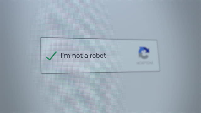 Mouse clicking on I'm not a robot button on a computer screen confirming that the user is human. Digital interface or website with cursor marking the checkbox to answer. Artificial intelligence