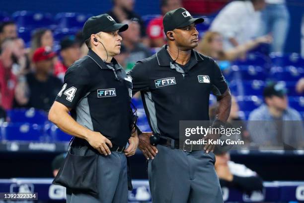 Home plate umpire Mark Wegner and umpire Alan Porter await the replay call in the top of the fourth inning at loanDepot park on April 17, 2022 in...