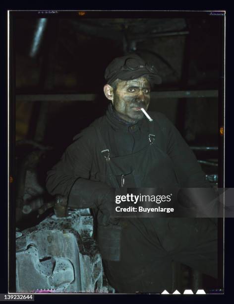 Year railroad veteran, William London works at the roundhouse at the Chicago & Northwestern Railroad's Proviso yards, Melrose Park, Illinois, 1942.