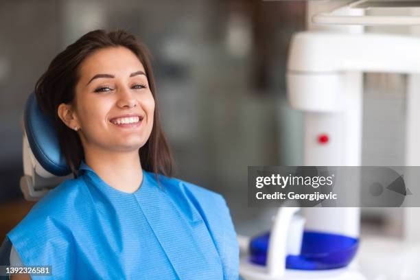 in dentist's chair - teeth whitening stock pictures, royalty-free photos & images