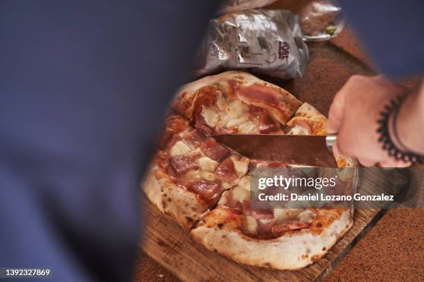 crop man cutting fresh pizza - pizza with ham stock pictures, royalty-free photos & images