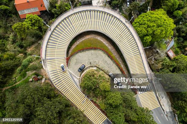 a sharply curved road - speed bump stock pictures, royalty-free photos & images