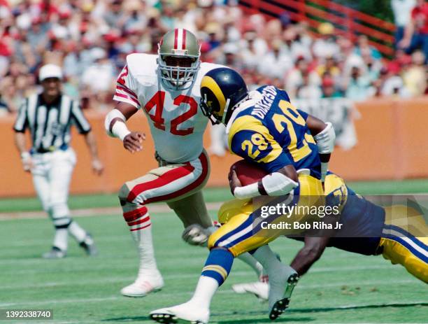 Los Angeles Rams Eric Dickerson runs against San Francisco 49'ers Ronnie Lott during Los Angeles Rams against San Francisco 49'ers game, September...