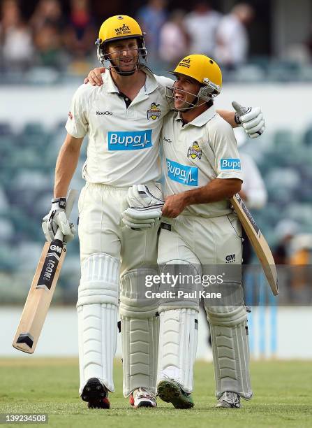 Adam Voges and Liam Davis of the Warriors head from field at stumps after a partnership of 343 runs during day two of the Sheffield Shield match...