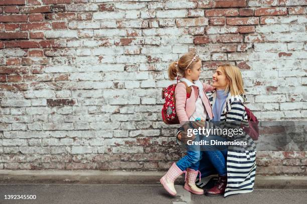 happy family of single mother and daughter together hugging - first day school hug stock pictures, royalty-free photos & images