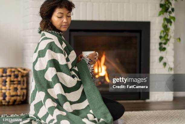 lounging around at home - sitting by fireplace stock pictures, royalty-free photos & images
