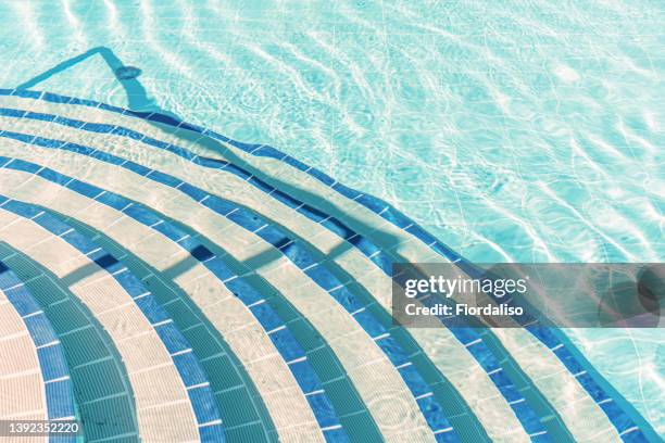 the steps of the pool are lined with blue and white ceramic tiles. spa area in a premium hotel - good condition stock pictures, royalty-free photos & images