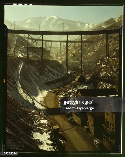 Carr Fork Canyon as seen from G bridge, Bingham Copper Mine, Utah, 1942. In the background can be seen a train with waste or over-burden material on...