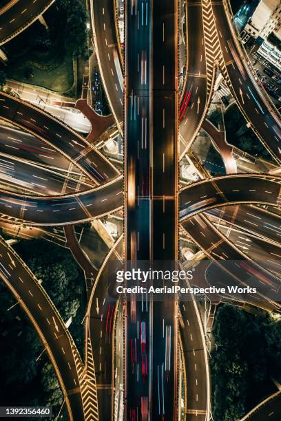 drone point view of overpass and city traffic at night - automotive stock pictures, royalty-free photos & images