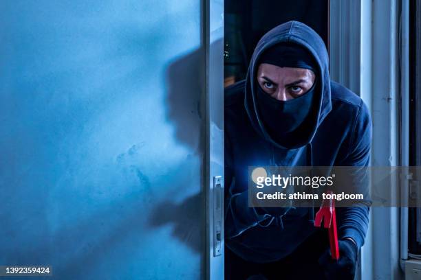a burglar with a crowbar broke the door and went to the house. - 侵入窃盗 ストックフォトと画像