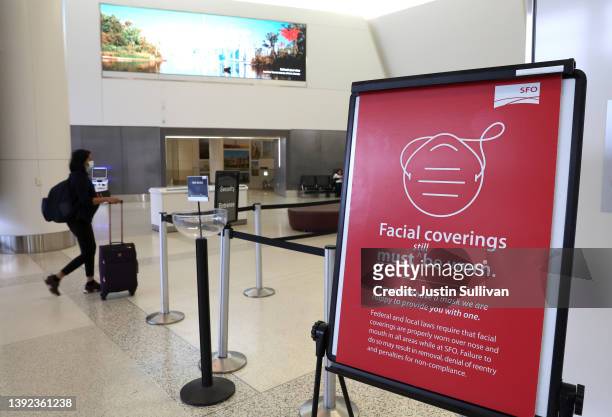 Sign stating that masks are required at San Francisco International Airport stands in a terminal after the federal mask mandate for airports and...