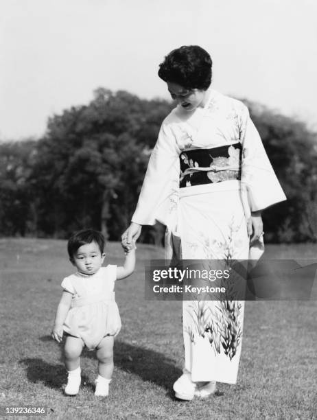 Prince Hiro, aka Crown Prince Naruhito of Japan, with his mother Empress Michiko in the grounds of Togu Palace in Tokyo, 8th May 1961.