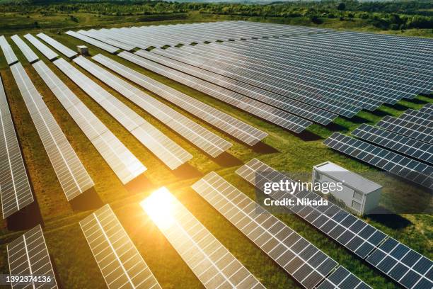 aerial view over solar cells energy farm in countryside landscape - renewable energy battery stock pictures, royalty-free photos & images