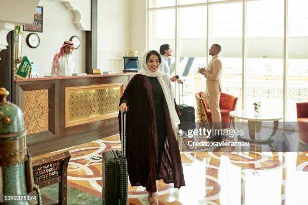 travelers in lobby of luxury hotel in riyadh, saudi arabia - saudi women stock pictures, royalty-free photos & images