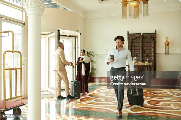 guests in lobby of luxury hotel in riyadh, saudi arabia - global entry stockfoto's en -beelden